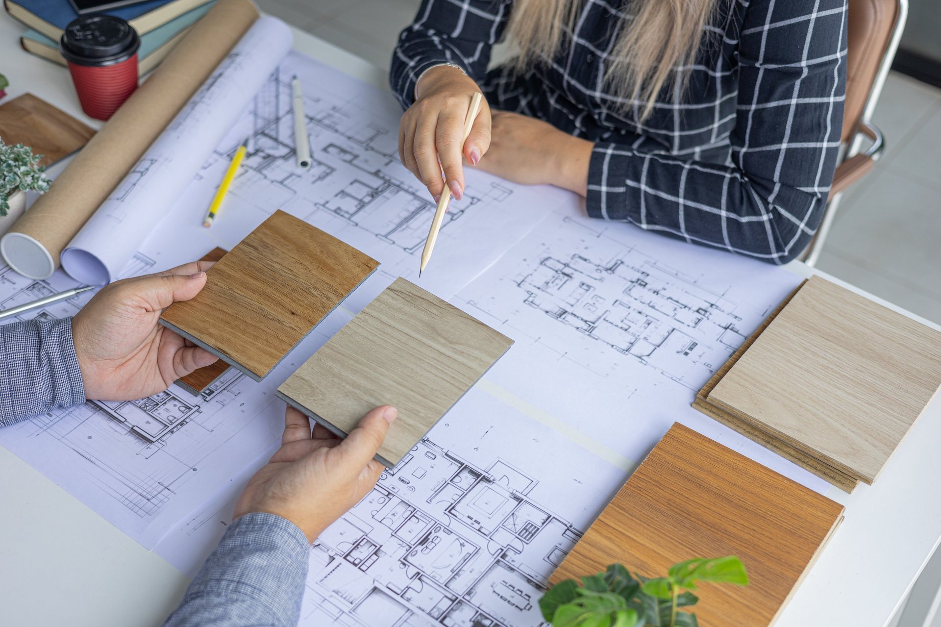 Closeup of Creative Architecture, Interior, Engineering Team Discussing Blueprint Layout and Renovation Materials.